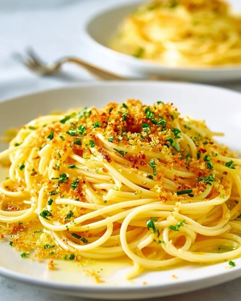 Plate of spaghetti with garlic and oil topped with parsley and parmesan cheese