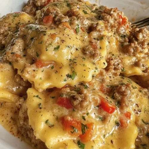 Creamy Cajun sausage ravioli served in a bowl with herbs and spices