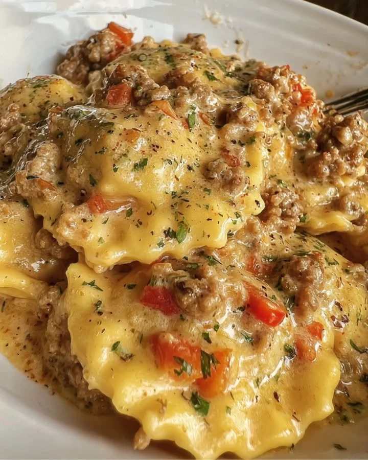Creamy Cajun sausage ravioli served in a bowl with herbs and spices