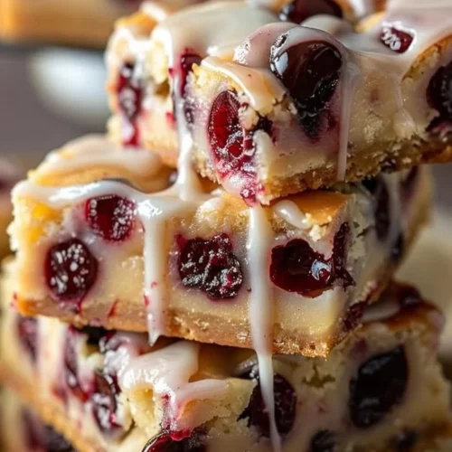 Creamy cherry almond cheesecake bars topped with cherry and almond garnishes