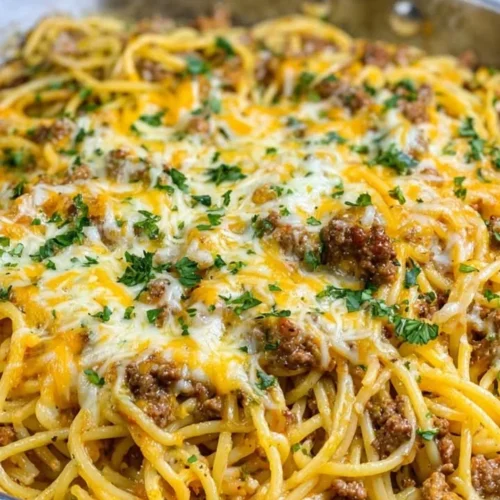 Delicious Garlic Butter Cajun Beef Spaghetti topped with Cheddar Parmesan Cream Sauce
