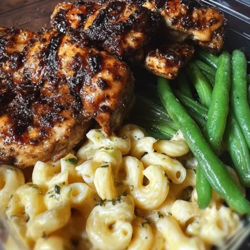 Glazed grilled chicken plate with fresh herbs and side vegetables