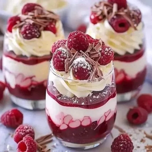 Heavenly raspberry mousse parfait with white chocolate topping