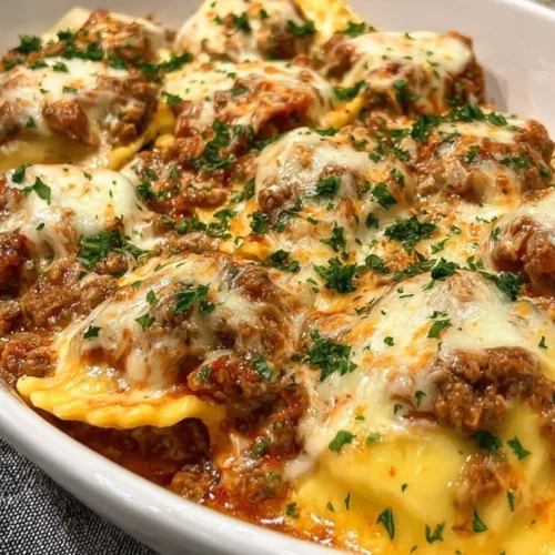 Plate of Million Dollar Ravioli garnished with fresh herbs and sauce