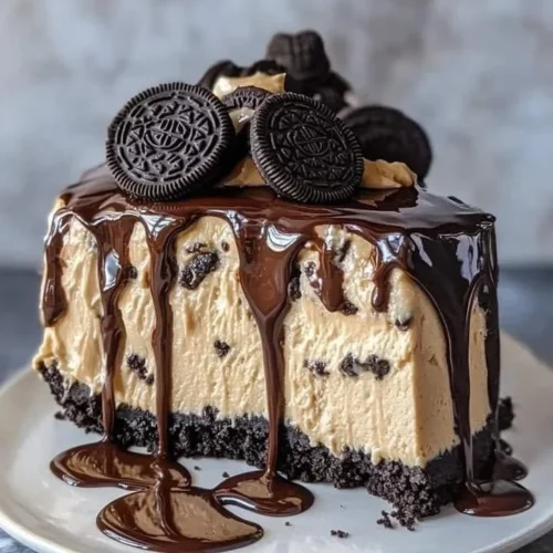 Oreo Peanut Butter Cheesecake Drip Cake topped with chocolate ganache