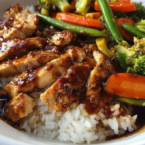 Delicious Teriyaki Chicken Rice Bowl with colorful vegetables and flavorful sauce.